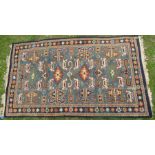 An Eastern design rug, decorated in blue and orange with repeating symbols, 39ins x 68ins