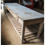 A large pine and formica topped table, fitted with two frieze drawers to a slatted shelf, 96ins x