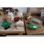 A collection of money boxes, including continental examples and a Beswick bull money box