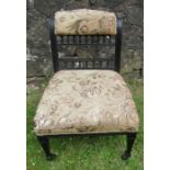 A 19th century ebonised and upholstered nursing chair