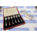 Two silver toast racks and a set of cased silver coffee spoons