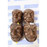 A set of four ceramic gargoyle brackets