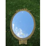 A 19th century oval gilt frame mirror, with beveled plate