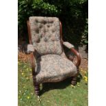 A 19th century showwood open armchair,  with deep buttoned back, raised on front trimmed legs