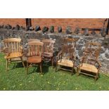 A collection of kitchen chairs, to include a pair of rush seated open armchairs, three single chairs