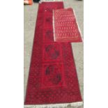An Eastern design red ground runner, 32ins x 116ins, together with another rug, 24ins x 51ins