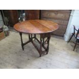 An 18th century yew wood gate leg table, raised on turn baluster legs, 45ins x 39ins, height 29ins