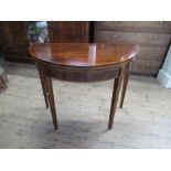 A 19th century mahogany half round fold over table, with cross banded border, 36ins x 18ins x 24.