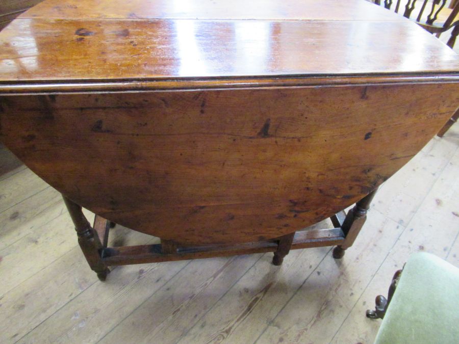 An 18th century yew wood gate leg table, raised on turn baluster legs, 45ins x 39ins, height 29ins - Image 5 of 5