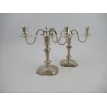 A pair of silver three light candelabra, with knop stems and raised on square bases, London 1967,