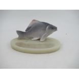 A Royal Copenhagen fish, on a onyx base, fish has a chip to the fin