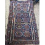 An Eastern design rug, the field decorated with hooked gull motifs, to a blue ground, 88ins x 51ins