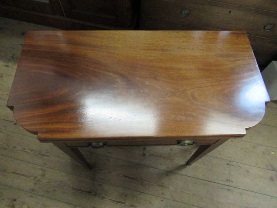 A 19th century mahogany break front fold over tea table, fitted with a drawer , raised on six - Image 2 of 4