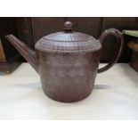 A large 18th Century Georgian red glazed earthenware teapot, and cover, with engine turned