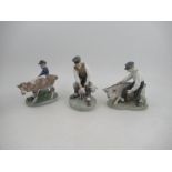 Three Royal Copenhagen porcelain models, boy with pig, numbered 848, boy with calf, numbered 772 and