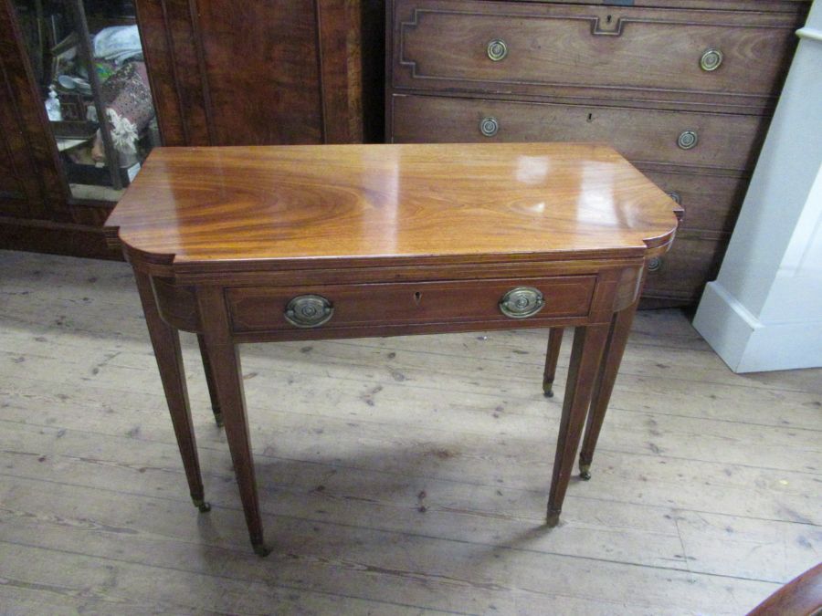 A 19th century mahogany break front fold over tea table, fitted with a drawer , raised on six