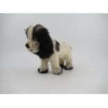 An English teddy Spaniel dog, in black and white plush, height 9.5ins, length 14ins