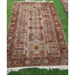 An Eastern design rug, decorated with a burgundy medallion field, 86ins x 56ins