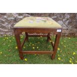 An antique mahogany framed foot stool