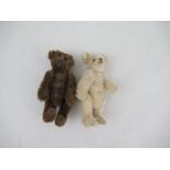 A Steiff miniature brown bear, height 3.75ins, together with another similar bear in pale plush,
