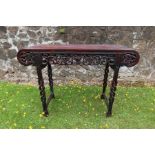 An antique Chinese altar table with carved frieze decoration and turned legs width  48ins, depth