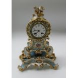 A French porcelain mantel clock, Rain Co, decorated with flowers to a blue and gilt ground, height