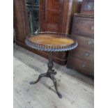 A circular mahogany occasional tripod table, with a gallery and gadroon border