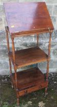 A 19th century rosewood what not having three tiers, the upper section with a ratcheted slope and