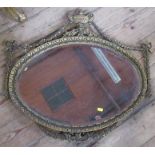 A oval gilt framed wall mirror with urn, swag and ribbon decoration