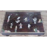 An Eastern design low coffee table, inlaid with figures in landscape, 20ins x 32ins, height 14ins