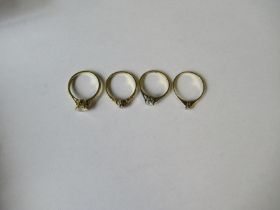 Four solitaire rings, two in 18ct gold, weight 8g