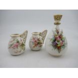 A Royal Worcester vase,  decorated with hand painted flowers to a white ground, with a pierced