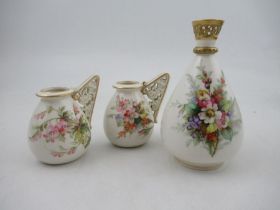 A Royal Worcester vase,  decorated with hand painted flowers to a white ground, with a pierced
