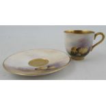 A Royal Worcester miniature coffee cup and saucer, both the cup and saucer decorated with sheep in