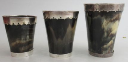 A graduated set of three silver mounted horn beakers, with glass bottoms, London 1872, height 3.5ins