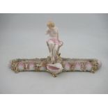 A Royal Worcester centre piece, decorated with a semi clad lady, the base decorated with shells,