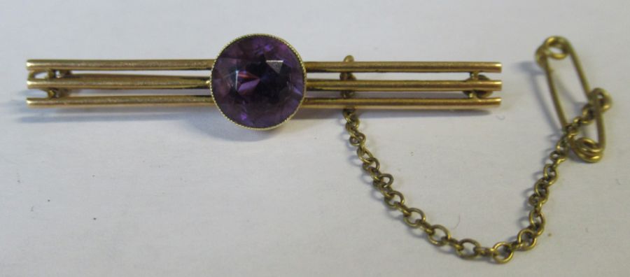 A yellow gold triple bar brooch, set with a stone, weight 3.5g