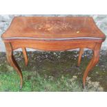 A 19th century quarter veneered fold over mahogany games table, with inlaid floral decoration,