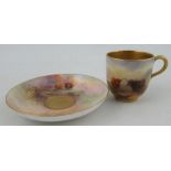 A Royal Worcester miniature coffee cup and saucer, both the cup and saucer decorated with Highland