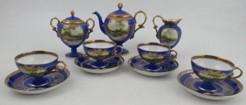 A Noritake coffee set, decorated with landscapes to a blue ground, comprising four cups and saucers,