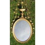 A gilt framed wall mirror, with urn and flower decoration