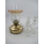 An oil lamp and three decanters