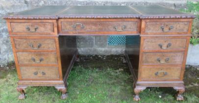 A Georgian design walnut writing desk fitted with three frieze drawers over two pedestal, of three