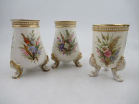 A pair of Royal Worcester vases, decorated with floral sprays, with jewelled decoration, raised on