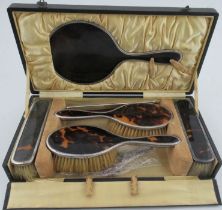 A cased six piece silver and tortoiseshell dressing table set