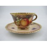 A Royal Worcester cabinet cup and saucer, decorated with hand painted fruit, signed N.Creed