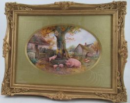 A Royal Worcester framed oval porcelain plaque, decorated with pigs around a pump trough with a tree