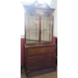 A Regency mahogany and inlaid secretaire bookcase, with inlaid decoration, the upper glazed