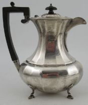A silver coffee pot, of oval baluster form, raised on four scroll feet, Sheffield 1916, weight