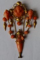 A 19th century Italian carved coral and gold pendant brooch, having oval carved coral bust portrait,